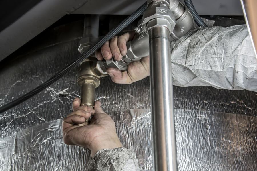 Plombier travaillant sur des tuyaux